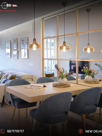 This bright and airy dining space uses a large mirror-paneled wall to create an illusion of spaciousness. The simple wooden dining table is paired with comfortable upholstered chairs, perfect for a modern, minimalist home.
