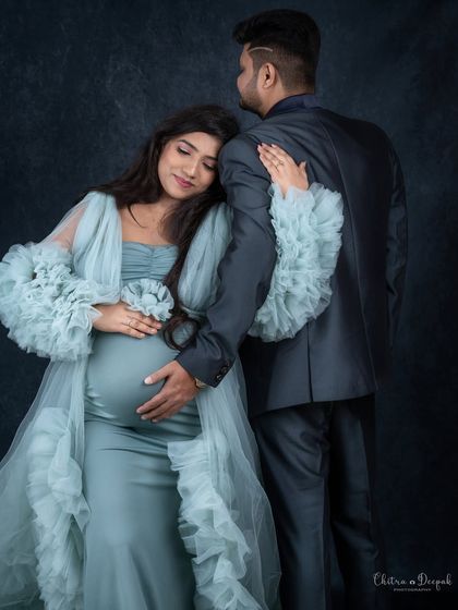 A tender and protective embrace. This pose from behind is intimate and beautifully showcases the baby bump.