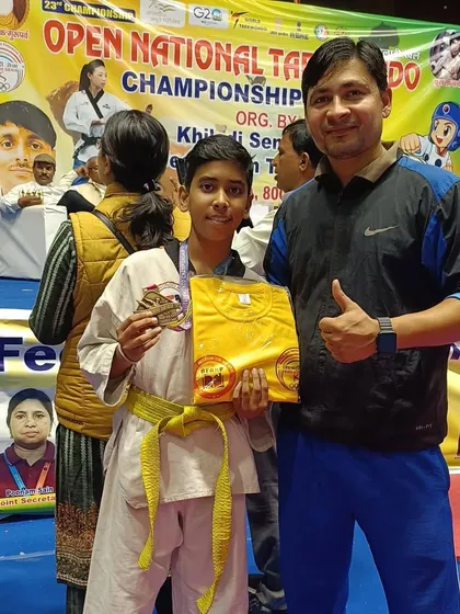 This student is happy with his bronze medal and prize from the national championship.