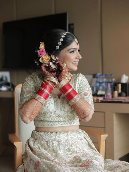 Putting on her earrings, this candid shot shows the beautiful floral hair accessories we used.