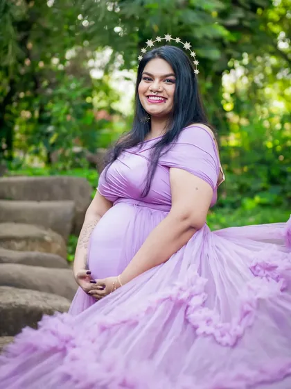 A radiant solo portrait of the mom-to-be. Her smile and the beautiful lavender gown create a feeling of pure joy and anticipation.