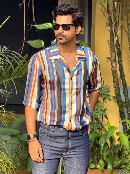 Stay refreshed and stylish with our vibrant multi-colored striped shirt. The vertical stripes and relaxed collar make it a perfect choice for summer days.