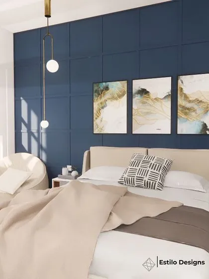 For this daughter's room, I used a deep blue accent wall with subtle molding to create a sophisticated backdrop. The design combines modern cottage elements with sleek furniture and abstract art, resulting in a chic and personal space.