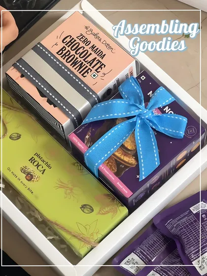 Assembling the goodies for the first birthday return favors. Each item, from the pistachio roca to the chocolate brownie, is carefully chosen and arranged.