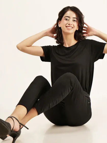 A cheerful, seated pose that feels natural and approachable, perfect for brands wanting to connect with their audience.