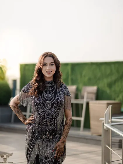 A bright and happy portrait of the bride-to-be on a rooftop. Her confident pose and beautiful smile capture the joyful spirit of her pre-wedding celebration.