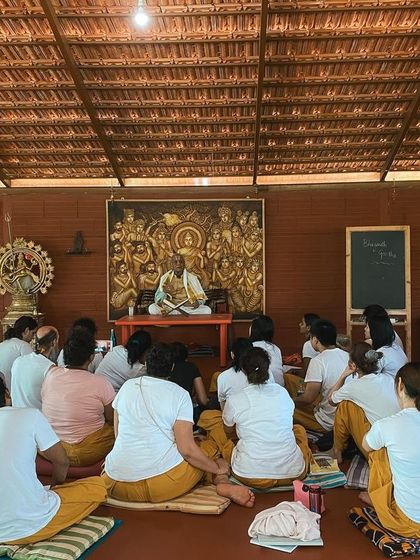 Students listen intently during a lecture in the shala. Our curriculum covers everything from the Yoga Sutras of Patanjali to the principles of Ayurveda, providing a comprehensive education.