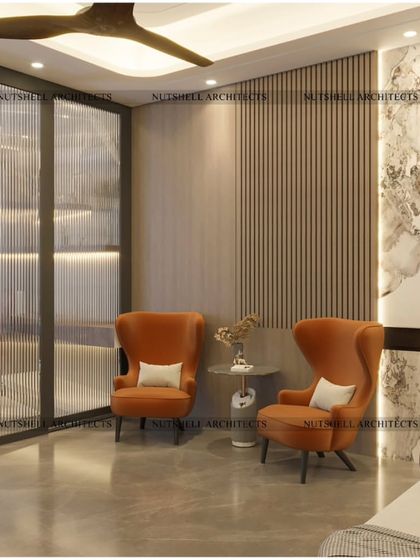 This family lounge is designed as a cozy retreat. We used fluted glass partitions to create a sense of separation without closing off the space, and comfortable wingback chairs in a warm terracotta hue invite you to relax.