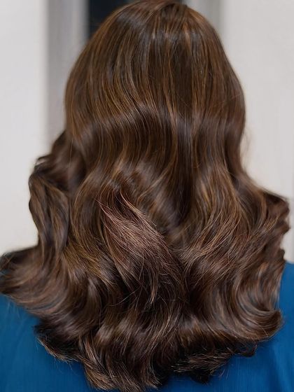 A beautiful example of a soft brown balayage, styled into gentle waves to create a sophisticated and modern look.