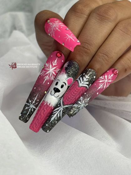 Another view of the pink and black winter nail set, with sparkling glitter and delicate snowflake designs.