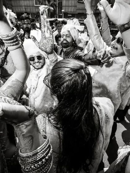 The energy of a Baraat on the streets of Gujarat. This black and white documentary shot captures the joy and chaos of the groom's procession.