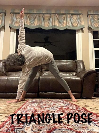 Practicing the Triangle Pose at home. This shows how you can use your own space to continue your practice, focusing on alignment and steady breathing.