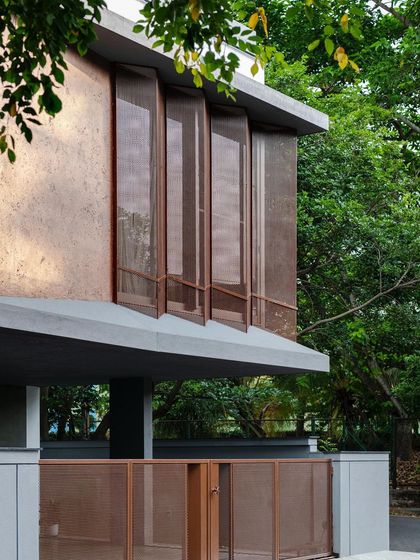 The upper level of the Copper House features folding perforated screens set within a copper-textured facade. These operable elements allow residents to modulate light, ventilation, and views, creating a dynamic and responsive building envelope.