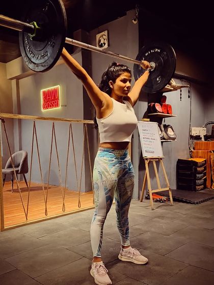 Holding an overhead squat, a movement that demands shoulder stability, core strength, and hip mobility. I believe that the more load you learn to handle, whether in the gym or in life, the stronger you become.