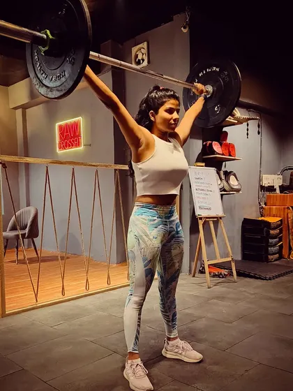 Holding an overhead squat, a movement that demands shoulder stability, core strength, and hip mobility. I believe that the more load you learn to handle, whether in the gym or in life, the stronger you become.