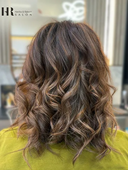 This balayage on a shorter, curly bob adds definition to the curls and a touch of sun-kissed brightness.