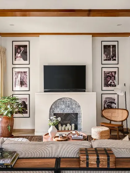 To create a cozy hub for family gatherings, I designed this Spanish-influenced fireplace as the room's focal point. The arched opening and patterned tile work add character, while the surrounding gallery wall makes it feel personal. It’s the perfect spot for movie nights or relaxing with a book.
