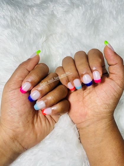 A super fun and colorful set. I used temporary extensions to create this rainbow French manicure, with a different neon color on each tip. Perfect for summer or a party.