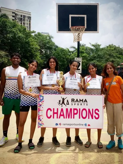 A proud coach with the champion girls' team. These victories are a testament to great coaching and dedicated practice.