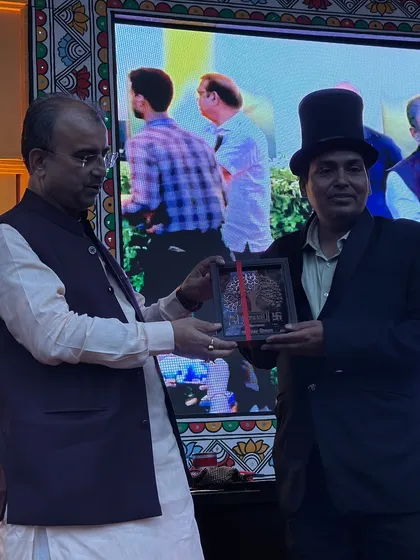 A closer shot of the award presentation. This kind of recognition from respected figures is a testament to the hard work and dedication I put into my craft.