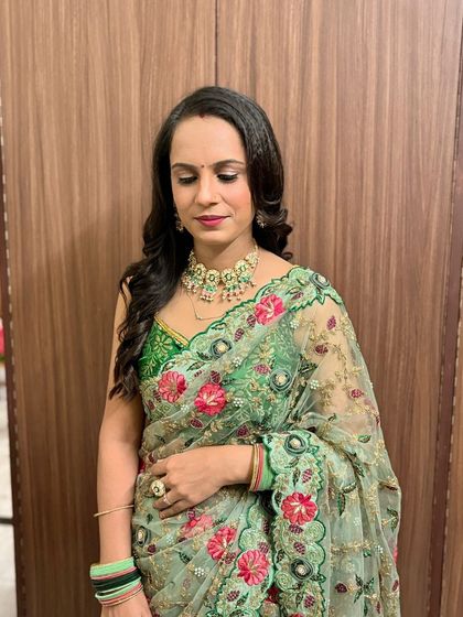 A soft and elegant party look. This client is wearing a beautiful green saree, and the makeup is kept fresh and glowing.