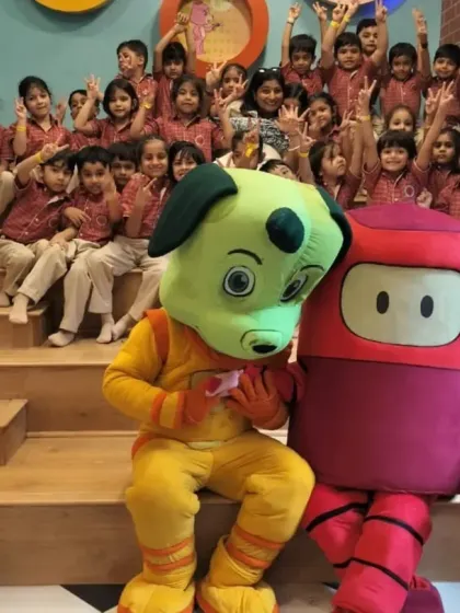 The excitement is clear on the faces of these students as they pose with Tinga Dojo and Popsy during their visit.