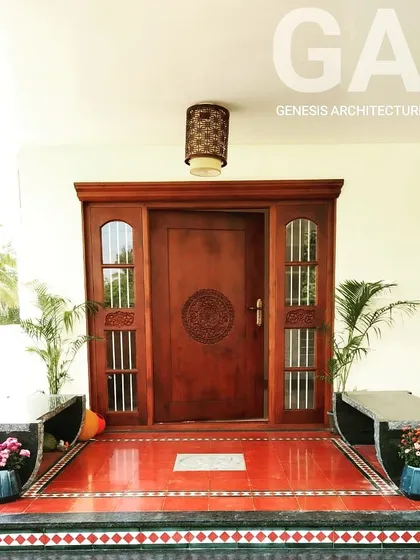 Our work often blends modern living with timeless traditions. This home entrance in Coimbatore features a beautifully carved wooden door and red oxide flooring, creating a warm, vernacular welcome that honors its cultural roots.