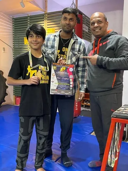 Posing with our young champion. We are incredibly proud to coach and guide the next generation of fighters.