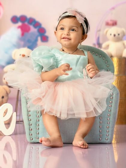 A happy smile from the birthday girl in her sweet and colorful Candyland setup.