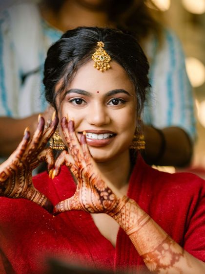 A fun and happy shot of Sugirtha during her makeover. Her genuine smile and playful pose capture the excitement of getting ready for her engagement.
