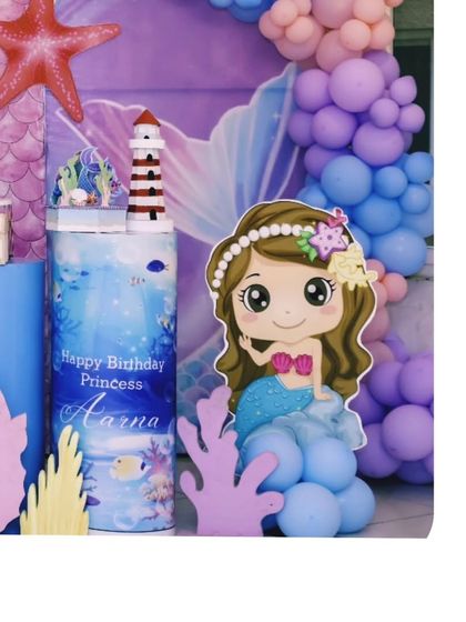 A cute mermaid cutout stands among the props for Aarna's birthday. I love creating these character elements to make the theme more personal and fun for the kids.