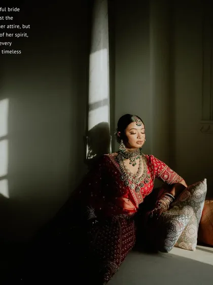 An artistic bridal portrait using natural light. The shadows create a dramatic and moody effect, highlighting the bride's contemplative expression and timeless grace.