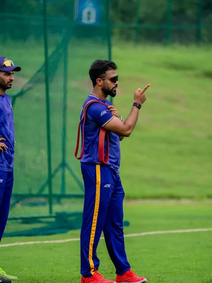 On the field, communication is key. Here I am during a training session, discussing strategy and technique with the players. My role extends beyond the gym to ensure the strength we build translates into smart, effective performance during a match.