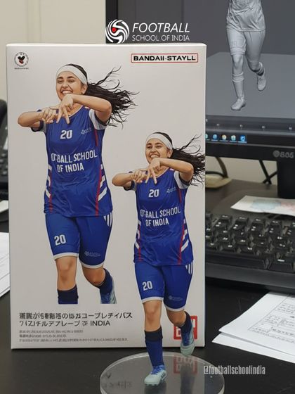 Celebrating a goal, now in figurine form. This creative image captures the joy of the game.