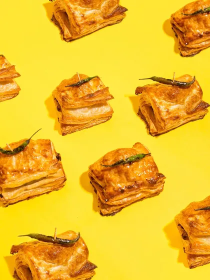 Here's my fun twist on a Mumbai classic, the Baked Vada Pav Puff. It has a spicy potato filling wrapped in a flaky, buttery puff pastry. It's the perfect savory snack for any occasion, especially a rainy day.