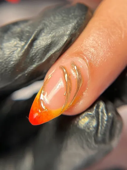 A macro shot of the gold chrome swirl detail. The way it sits on top of the sheer nude base is so elegant.