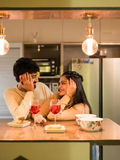 Sharing a glass of wine and quiet conversation in the comfort of your own kitchen. Our cozy home sessions are about capturing your love in the space where your story lives every day.
