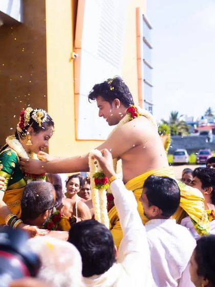 A wide shot of the Jeerige Bella ritual, showing the couple, their families, and the celebratory atmosphere.