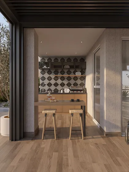 A compact outdoor kitchen and bar area is tucked into a corner of the terrace. The patterned tile backsplash adds a graphic element, while the wooden countertop and stools maintain a warm, natural feel, making it a perfect spot for casual entertaining.