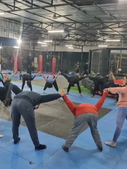 **Cooling down as a community.** Results happen over time. Here, our group performs a cool-down stretch together in a circle, reinforcing the supportive community atmosphere we cultivate at Warrior Fitflow.