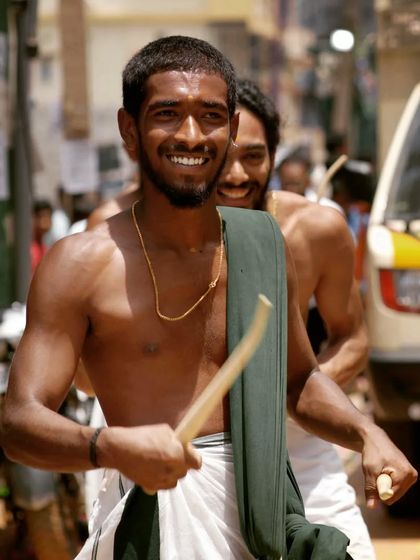 A huge smile that captures the sheer fun of performing Shinkarimelam for an appreciative crowd.