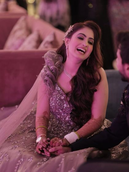 Laughter and love. This candid shot shows how her makeup looks just as beautiful in moments of joy. The long-wear formula ensures it stays perfect through the entire event.