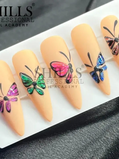A set of five stiletto nails, each featuring a different colored butterfly with sparkling wings on a matte nude background.