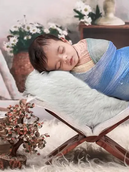 A creative variation of the bohemian theme, with the baby appearing to sleep on an open book, surrounded by serene decor.