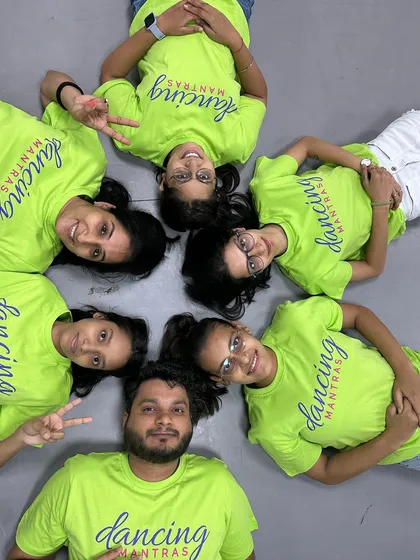 A creative 'Rule Breakers' group shot from above, showing off their team t-shirts and their fun-loving spirit.