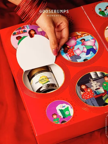 The interactive design of our 'Nok Jhok' box lets you tear open windows to reveal hidden treats, making the unboxing as fun as the flavours inside.
