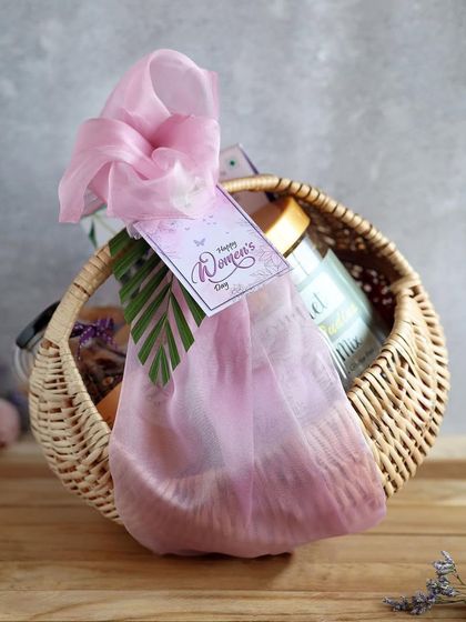 A simple wicker basket hamper for Women's Day, elegantly wrapped and perfect for a thoughtful gesture.