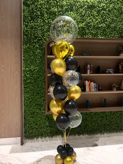 This tall, standing helium balloon bouquet makes a big impact. The black and gold color scheme is perfect for adding a touch of charm and elegance to any celebration.