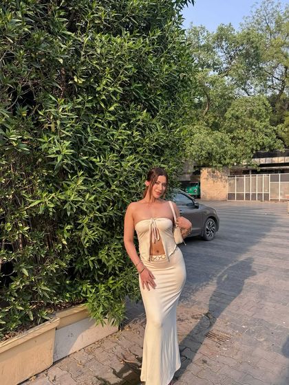 A full-length shot of the cream two-piece outfit.