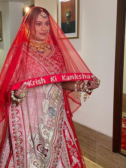My bride Kanksha, ready to make her entrance. The custom "Krish Ki Kanksha" veil adds a personal touch to her stunning traditional look.